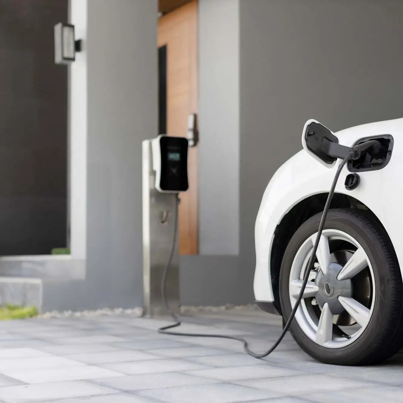 Progressive concept of EV car and home charging station in residential area. Progressive concept of EV car and home charging station powered by sustainable and clean energy with zero CO2 emission for green environmental. Charging point at residential area for electric vehicle.